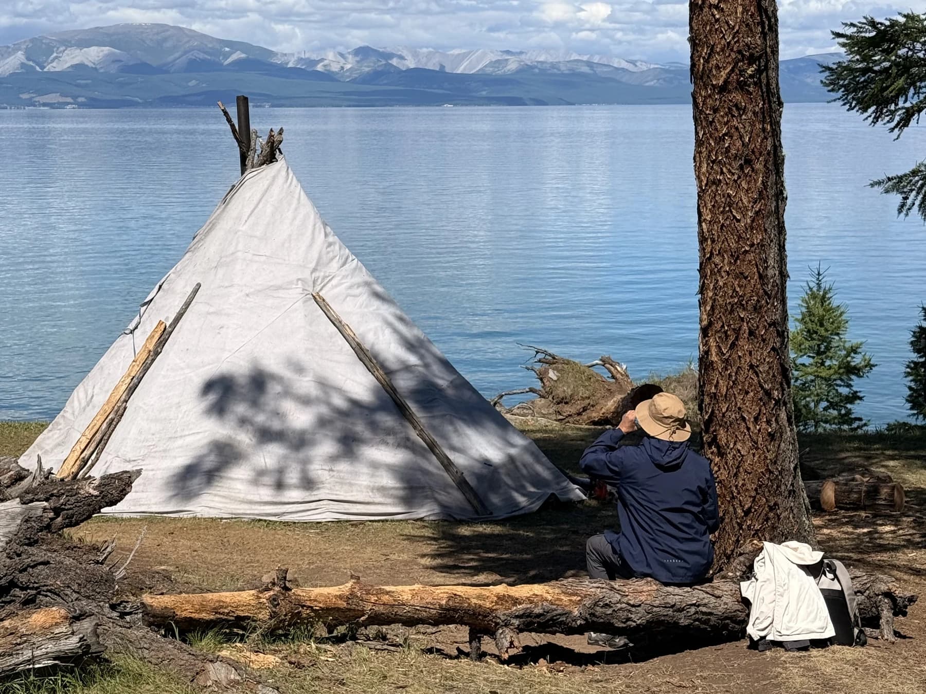 A lakeside camp beneath the forest