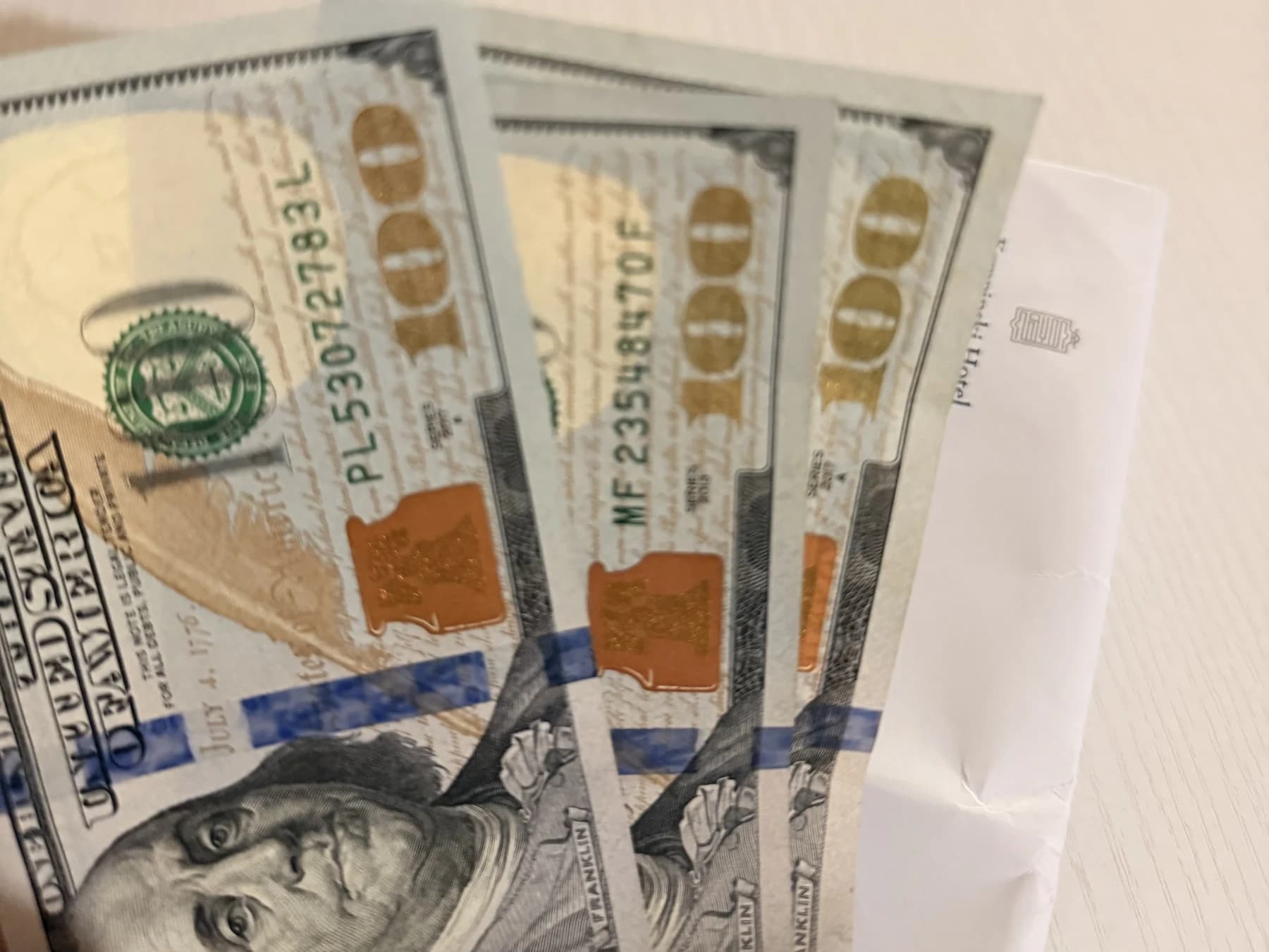 US dollar banknotes in an envelope